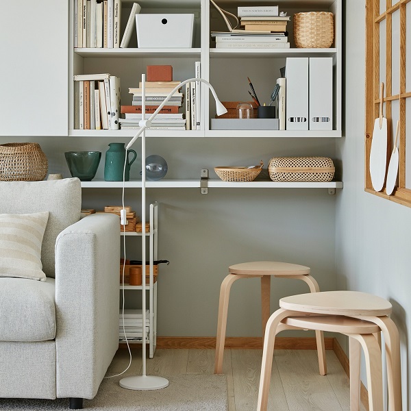 Three stackable KYRRE stools in birch are standing in a living room corner and offer extra seating when needed.