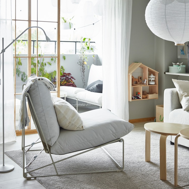 A HAVSTEN easy chair in a living room and HAVSTA 2-seat sofa on a balcony – they can be used both indoors and outdoors.