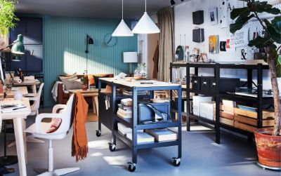  Workspace with two BROR black/wood trolleys with storage on castors, two white pendant lamps and a long black shelving unit.